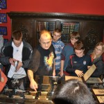 Founder Piotr Wojciechowski and school-aged guests in Eastern Europe’s first tattoo museum, in Poland.